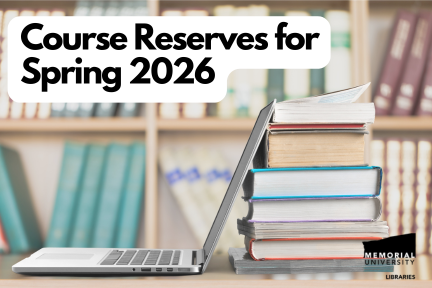 An open laptop and a stack of books on a table in front of a bookshelf